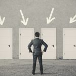 Businessman choosing the right door